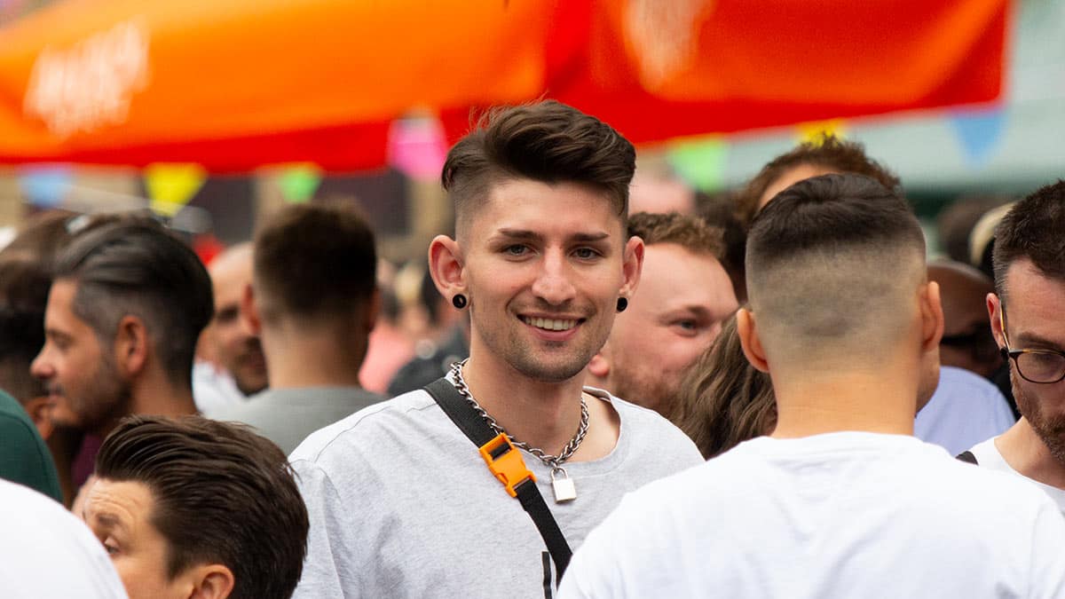 Smiling man in the crowd at Didsbury Pride 2021