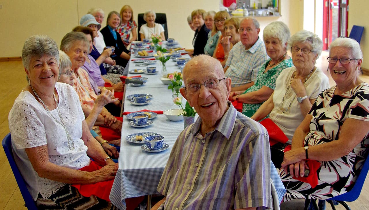An elderly group meeting enjoy afternoon tea
